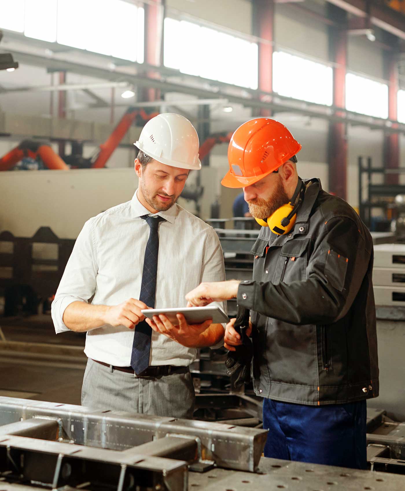 people working in a steel industry collaborating together to improve workflow and productivity
