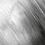 steel component close-up with graphs and scratches all in silver color