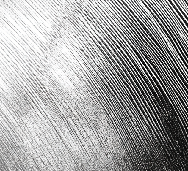 steel component close-up with graphs and scratches all in silver color